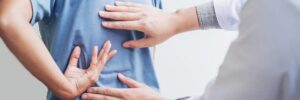 Physician attending patient back pain